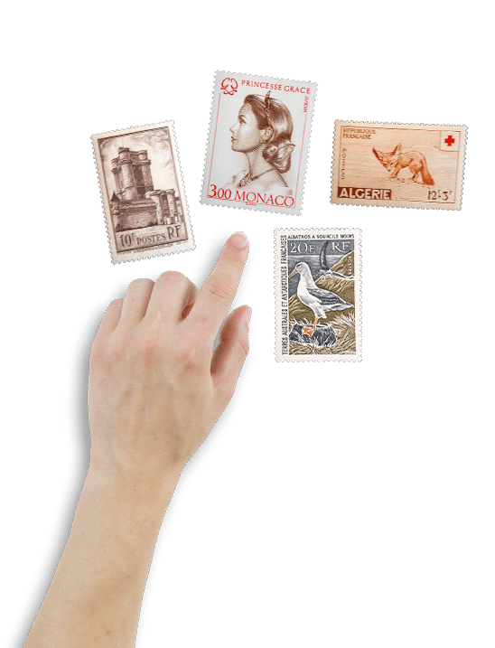 Main désignant quatre timbres de collection